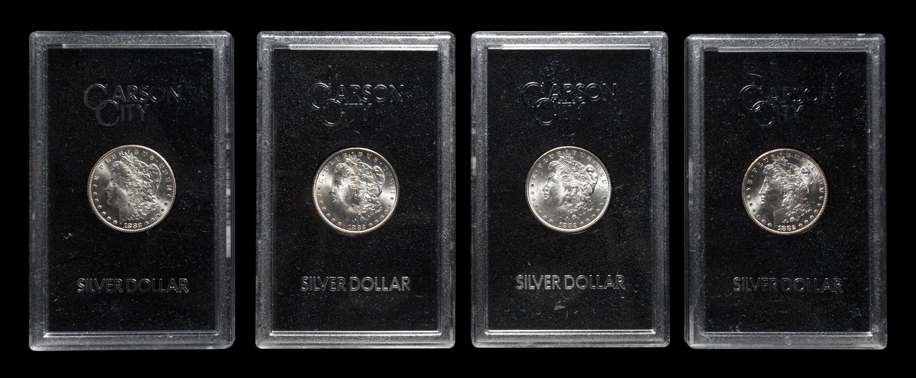 A Group of Four 1882-CC GSA: Morgan $1 Coins