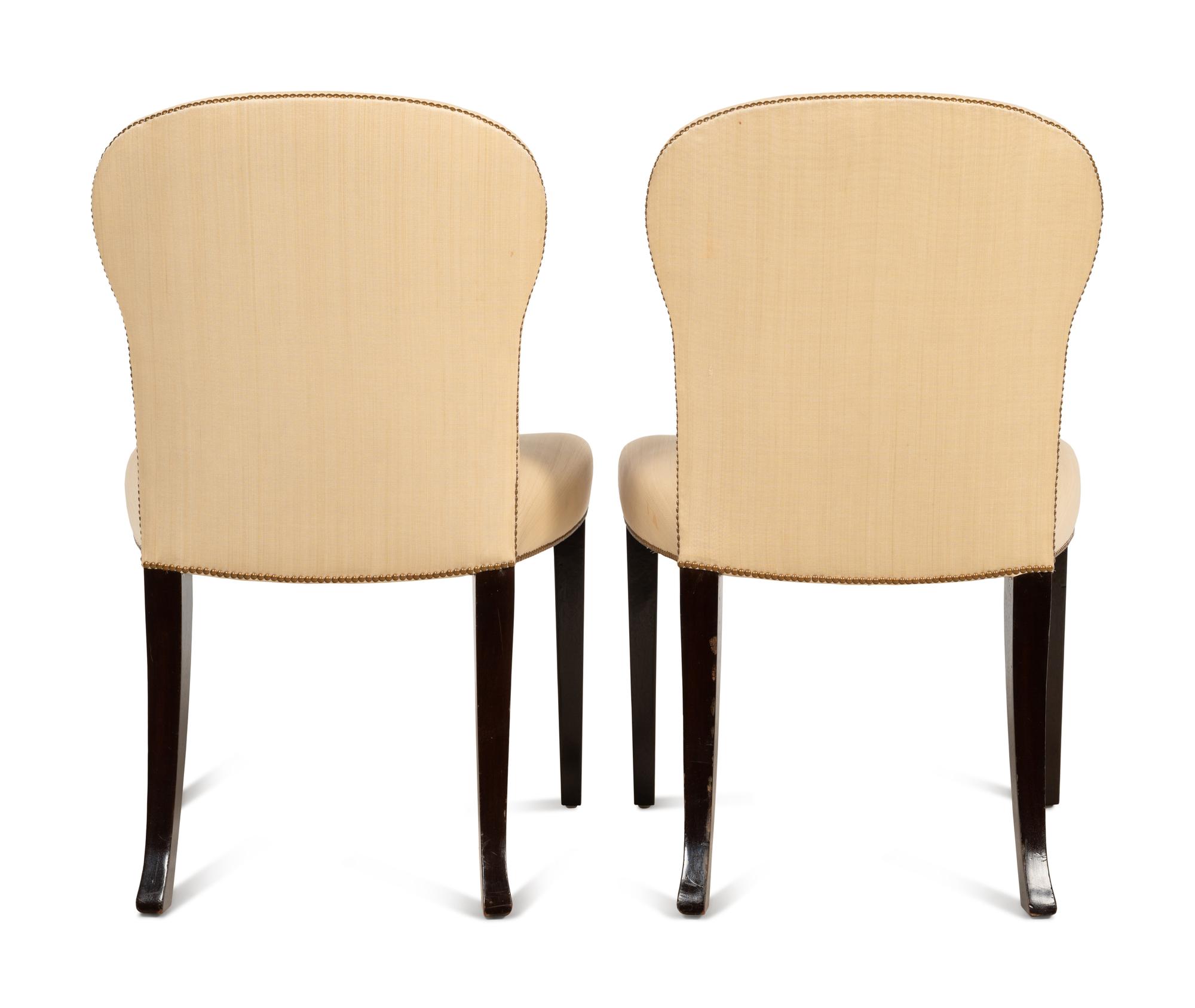 A Set of Eight Saddle Dining Chairs