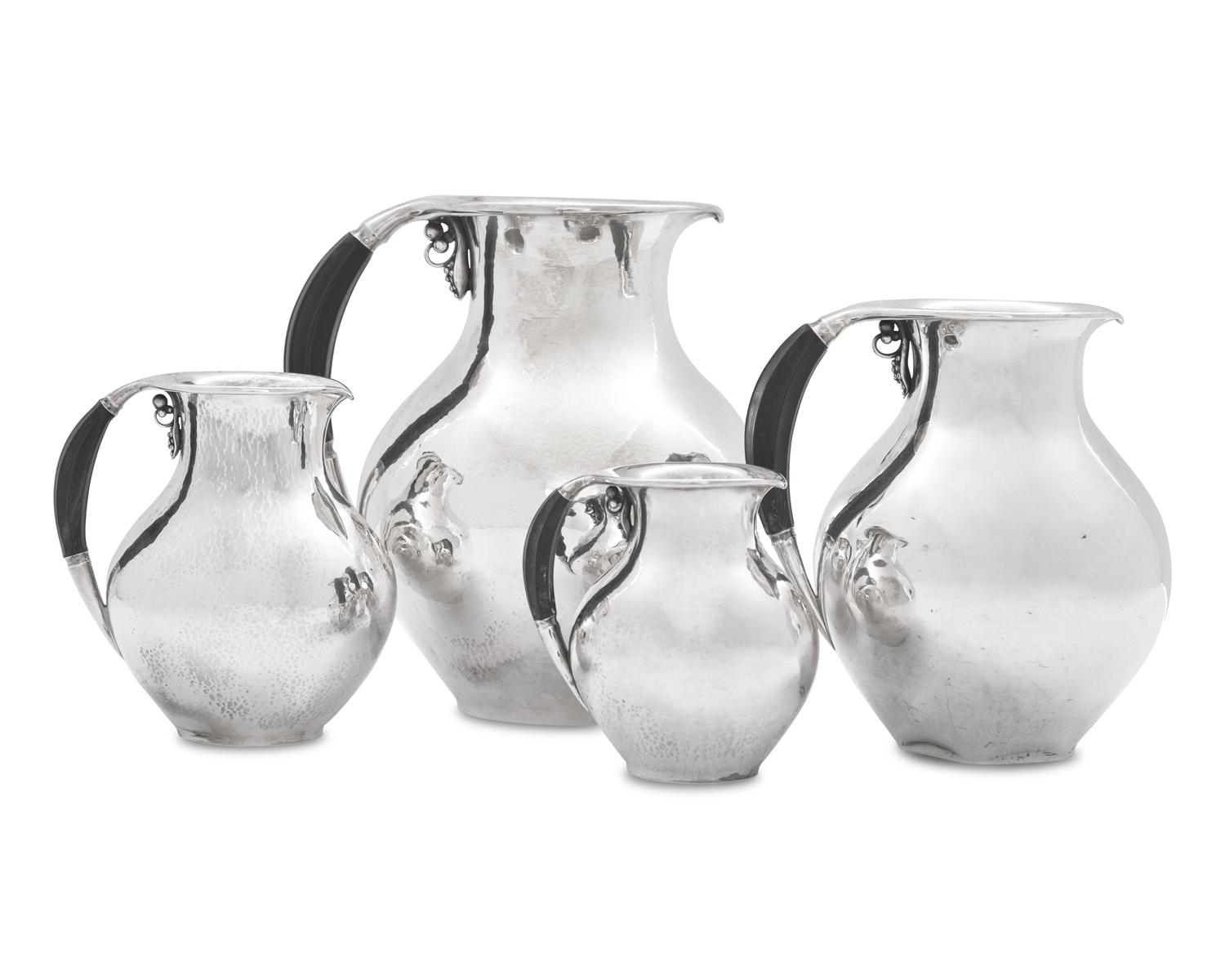 A Group of Four Georg Jensen Silver Pitchers