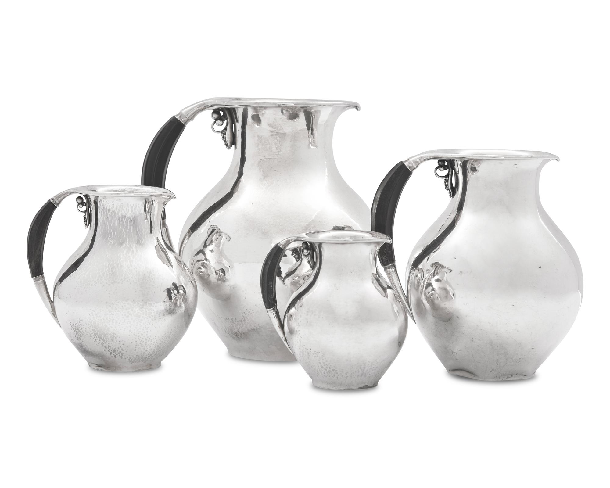 A Group of Four Georg Jensen Silver Pitchers