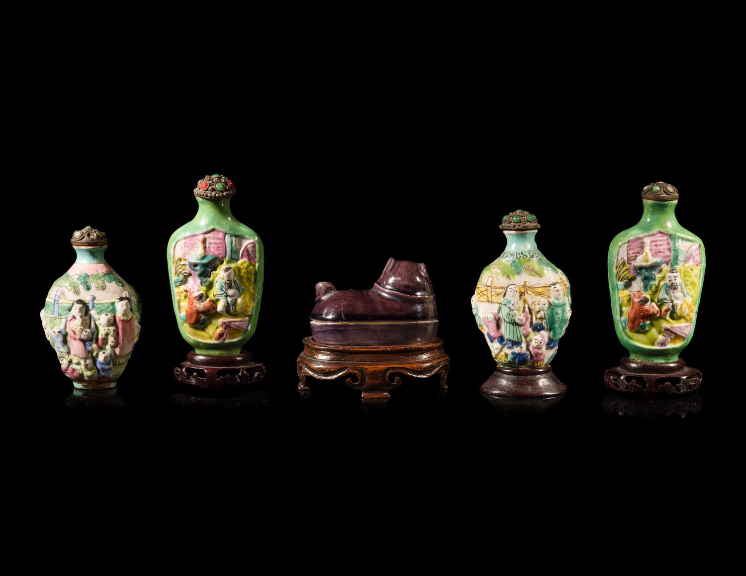 Four Chinese Famille Rose Porcelain Snuff Bottles and A Aubergine Glazed Porcelain Dog-Form Paper Weight