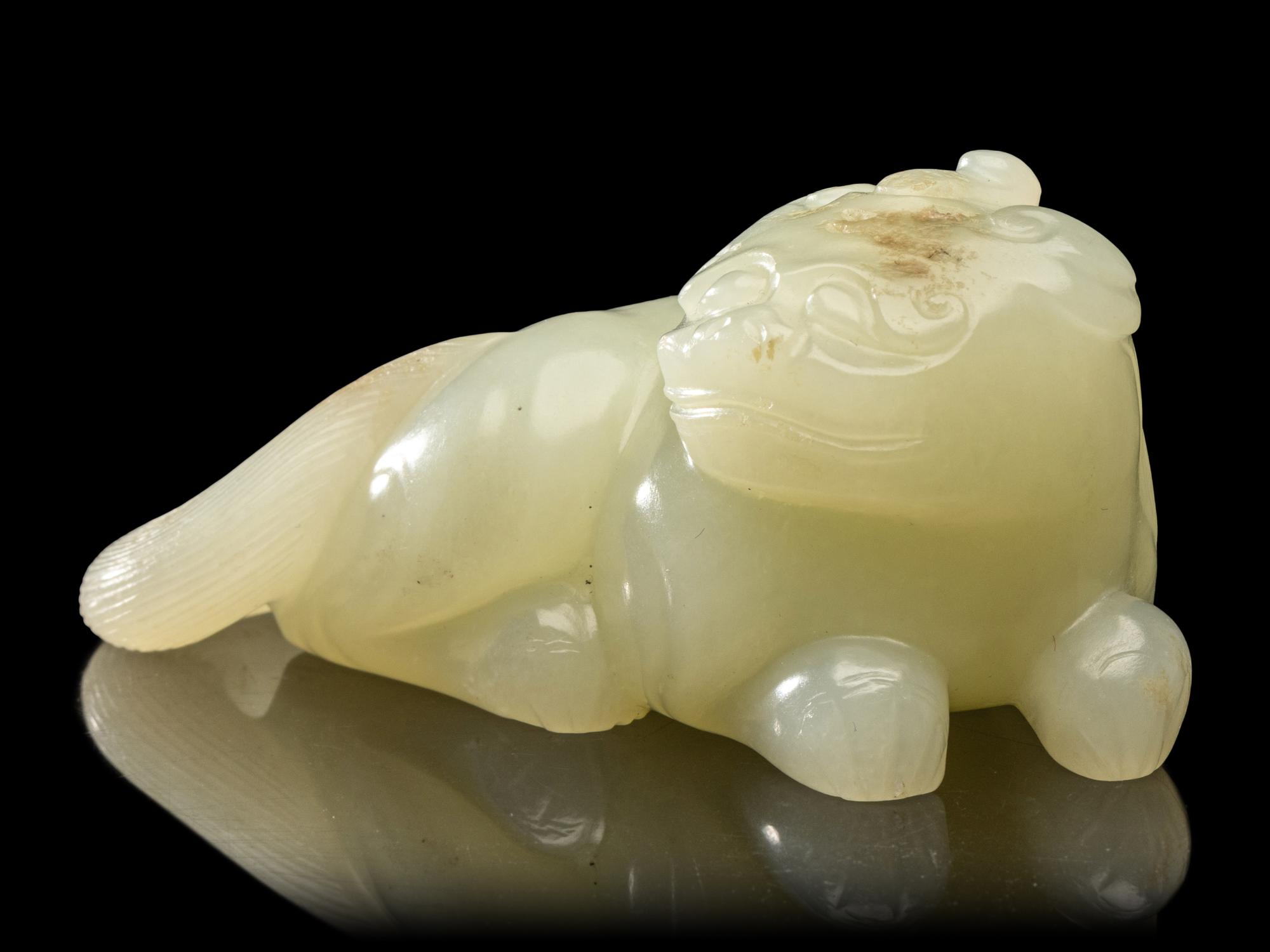 A Chinese Pale Celadon Jade Figure of a Mythical Beast, Early Qing Dynasty 清早期 青白玉瑞獸