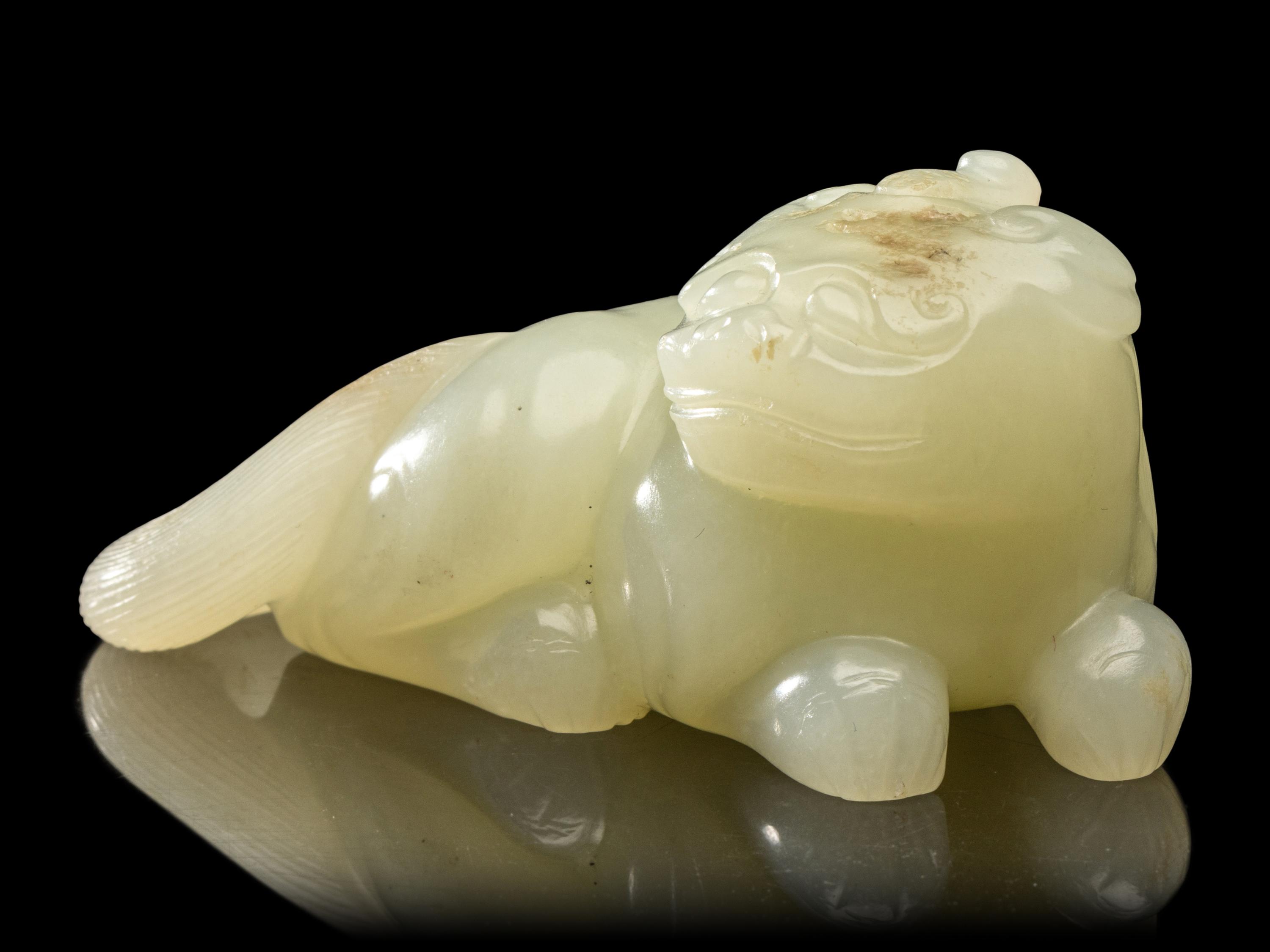 A Chinese Pale Celadon Jade Figure of a Mythical Beast, Early Qing Dynasty 清早期 青白玉瑞獸