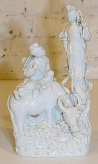 A Blanc de Chine Figural Group. Height 14 inches.
