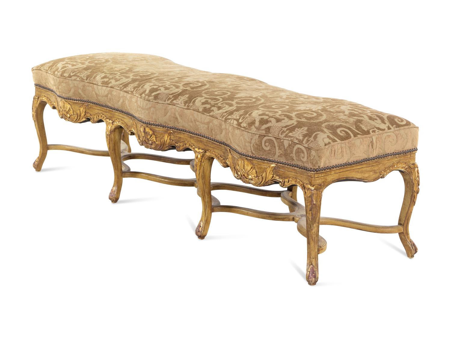 A Louis XV Style Carved Giltwood Serpentine Window Bench
