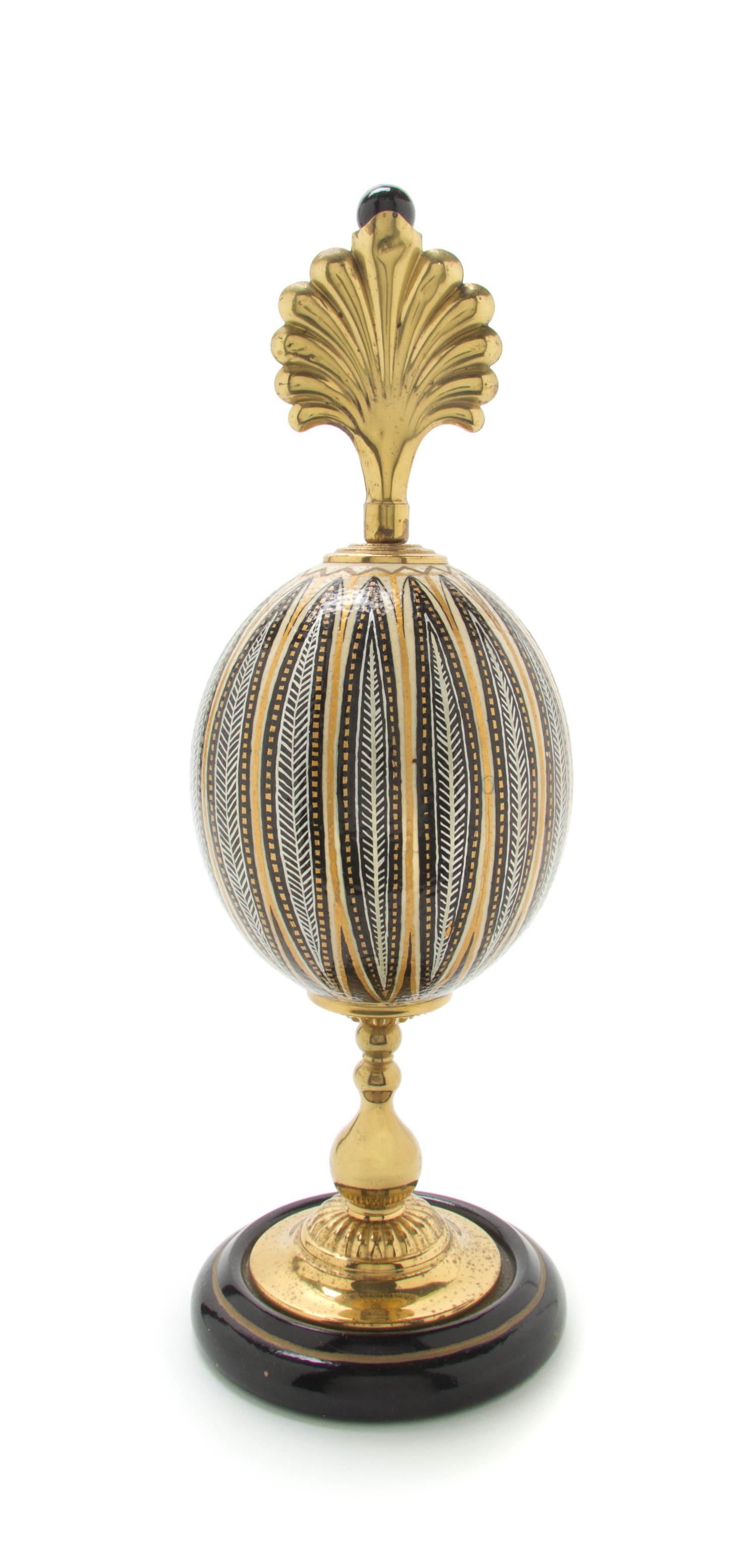 A Painted and Parcel Gilt Ostrich Egg Height overall 15 inches.