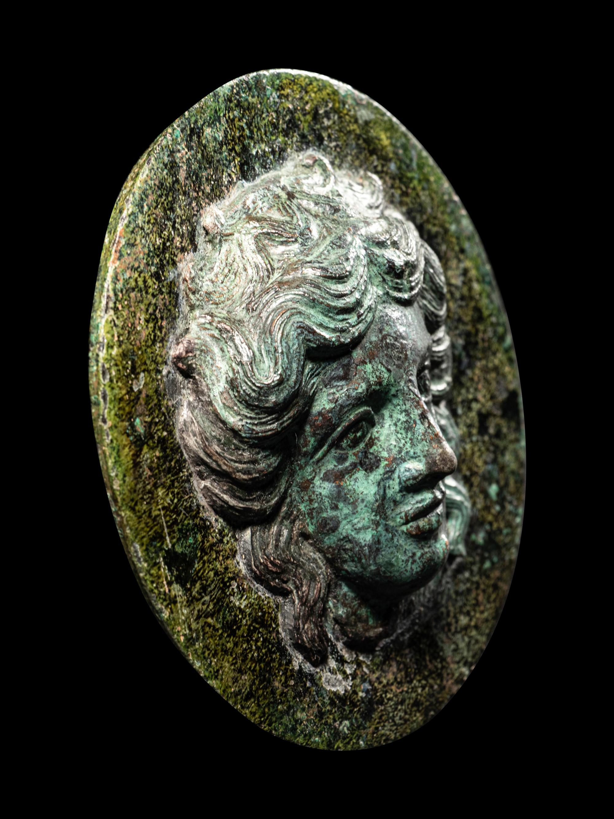 A Greek Bronze Mirror with the Head of a Woman