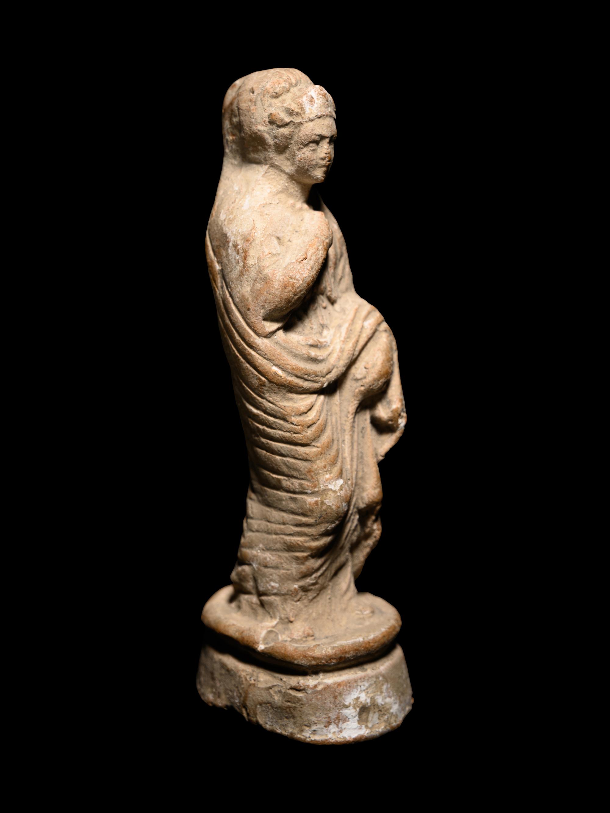 A Greek Terracotta Figure of a Young Woman