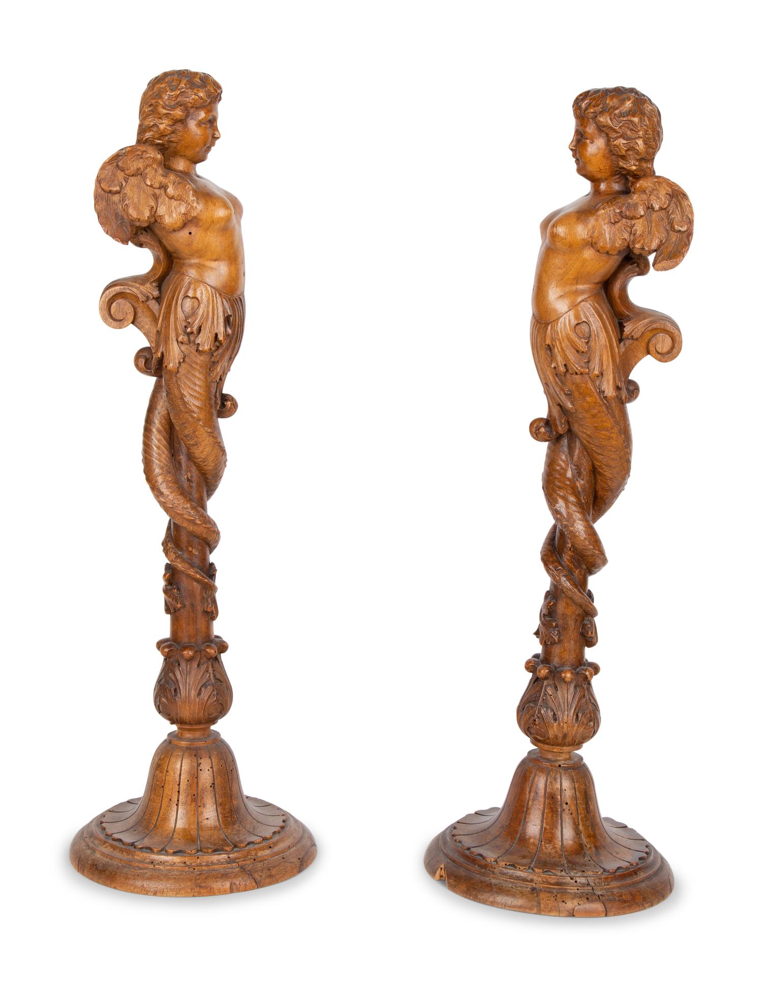 A Pair of Italian Carved Walnut Putti on Fluted Bases — 18TH/19TH CENTURY