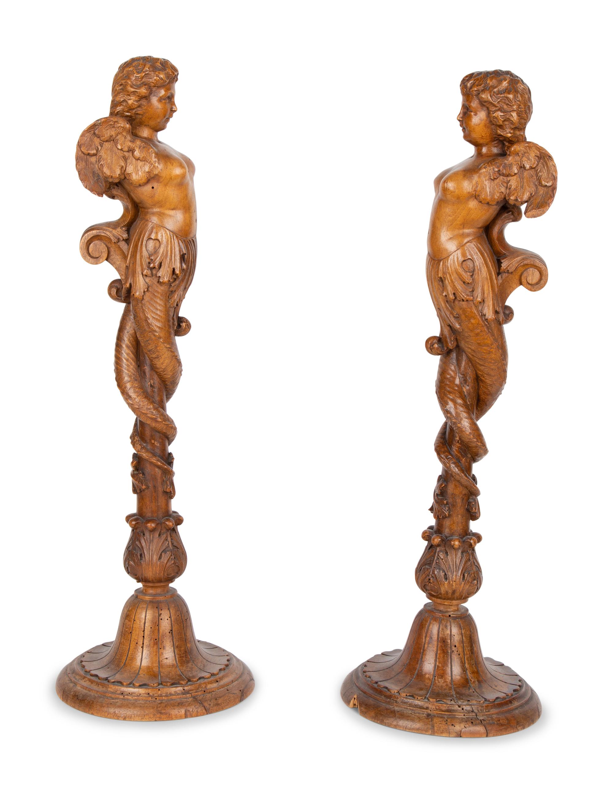 A Pair of Italian Carved Walnut Putti on Fluted Bases — 18TH/19TH CENTURY