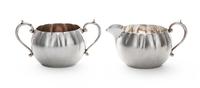 An American Silver Creamer and Sugar, Gorham Mfg. Co., Providence, RI, each oval, with fluted sides and C-scroll handles.
