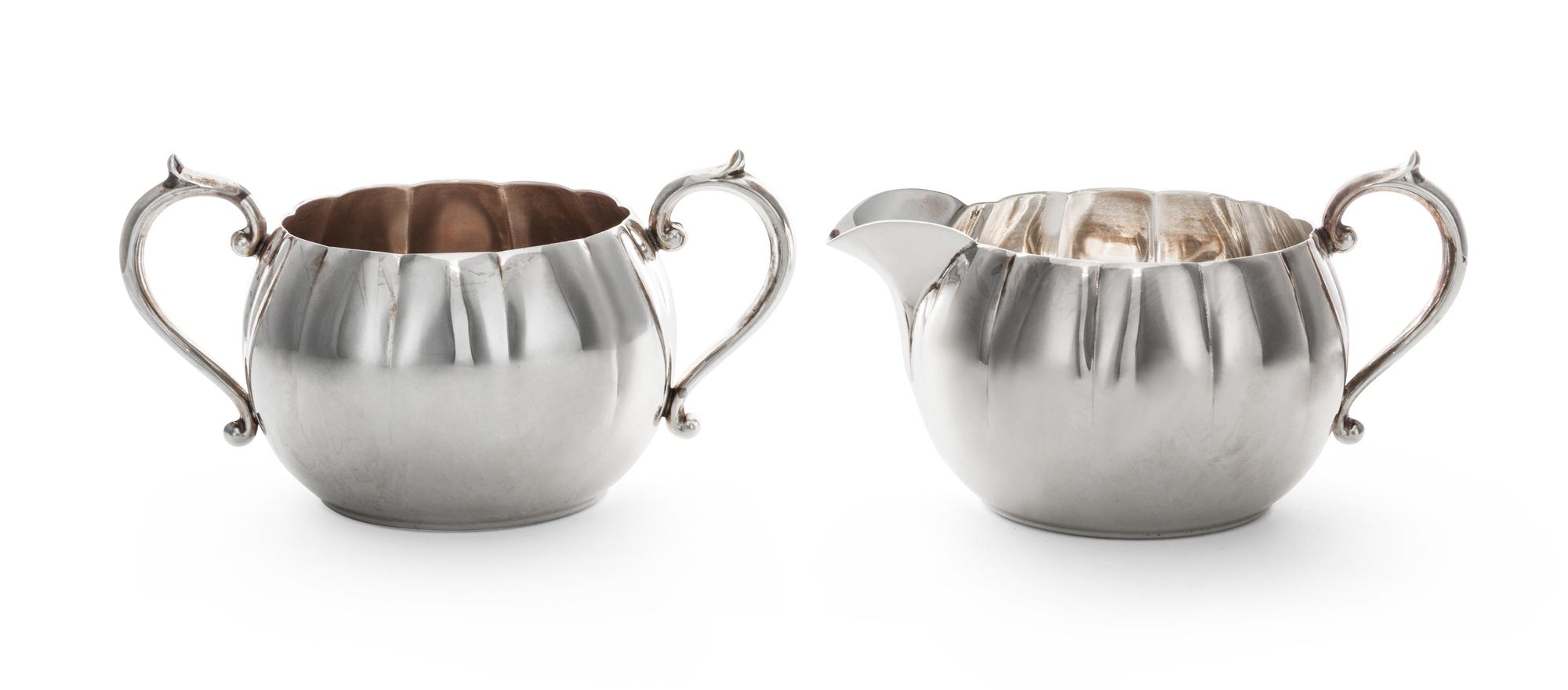 An American Silver Creamer and Sugar, Gorham Mfg. Co., Providence, RI, each oval, with fluted sides and C-scroll handles.