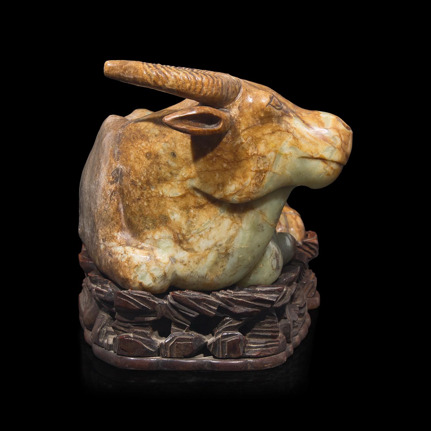 A Large Chinese Celadon and Beige Jade Buffalo, 18th/19th Century 清中期 青玉臥牛