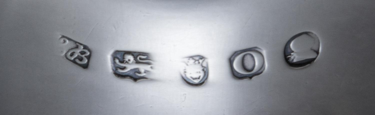 A Pair of George III Silver Sauce Boats, Hester Bateman, London, 1789, each having a foliate scroll handle and a beaded edge, raised on