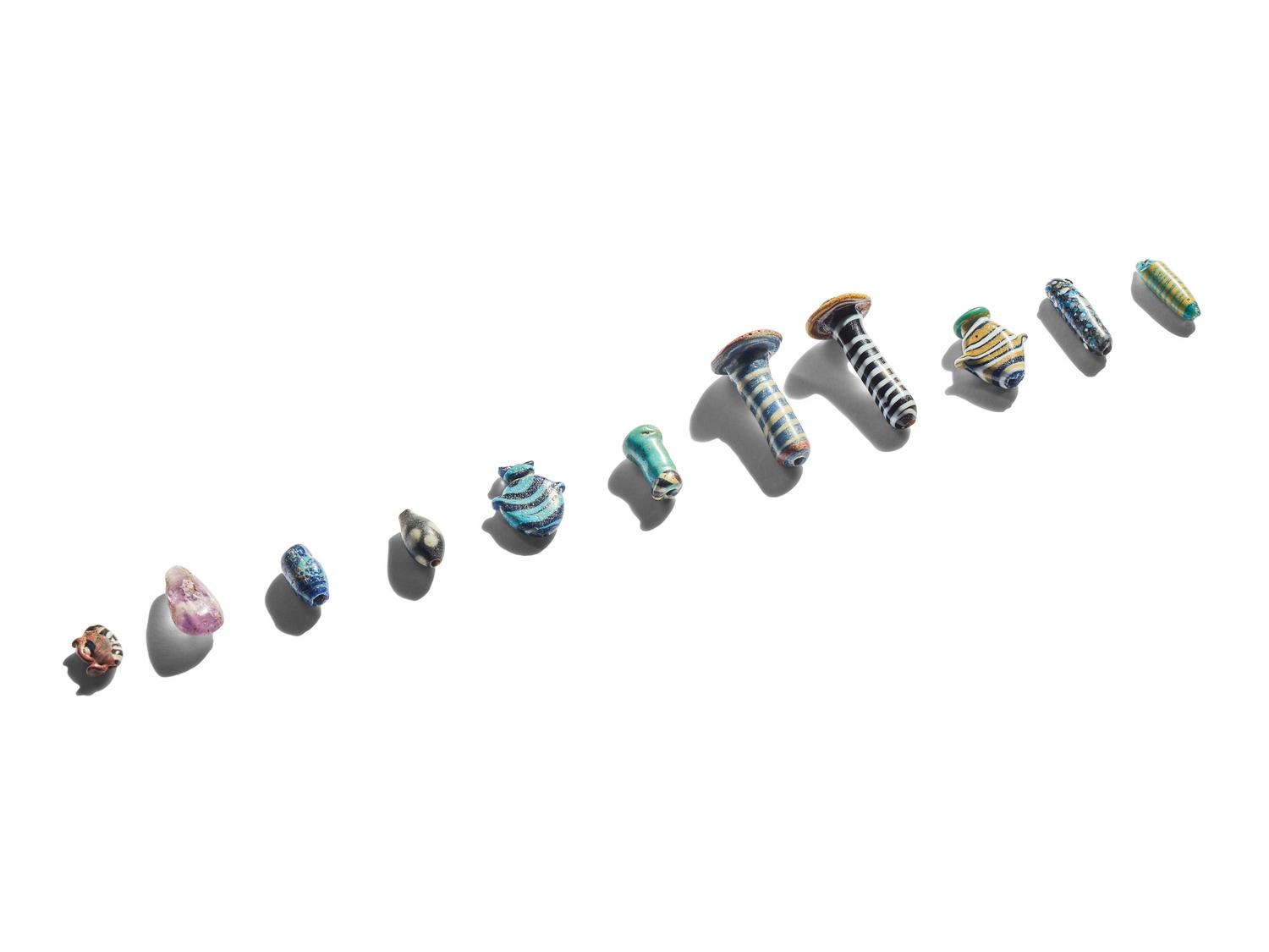 A Group of Eleven Glass Amulets and Ear Studs