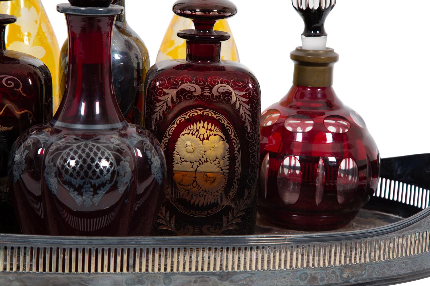 Eight Colored Glass Decanters and a Silver-Plate Galleried Serving Tray