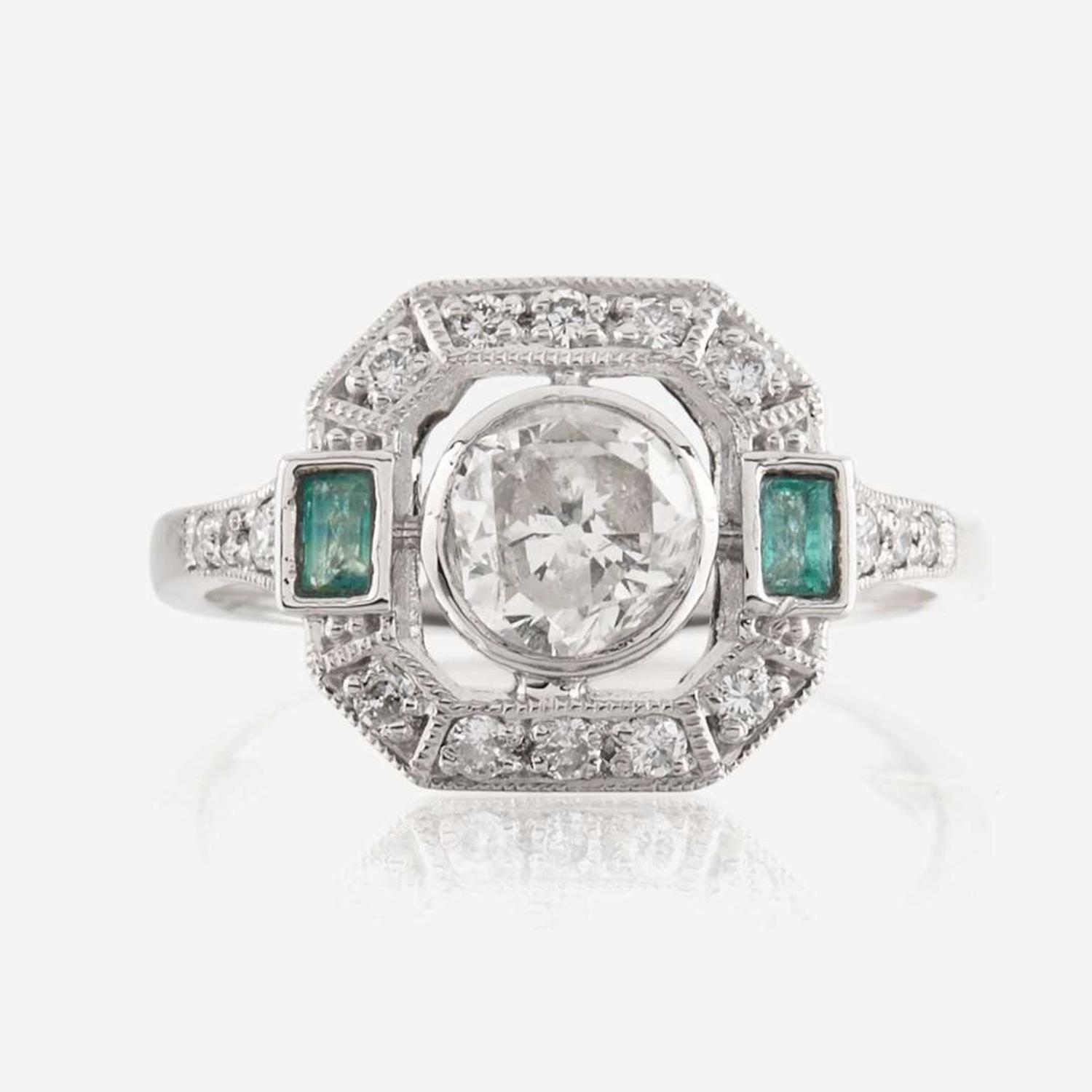 A diamond, emerald, and platinum ring