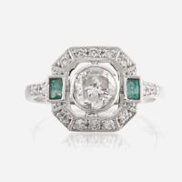A diamond, emerald, and platinum ring