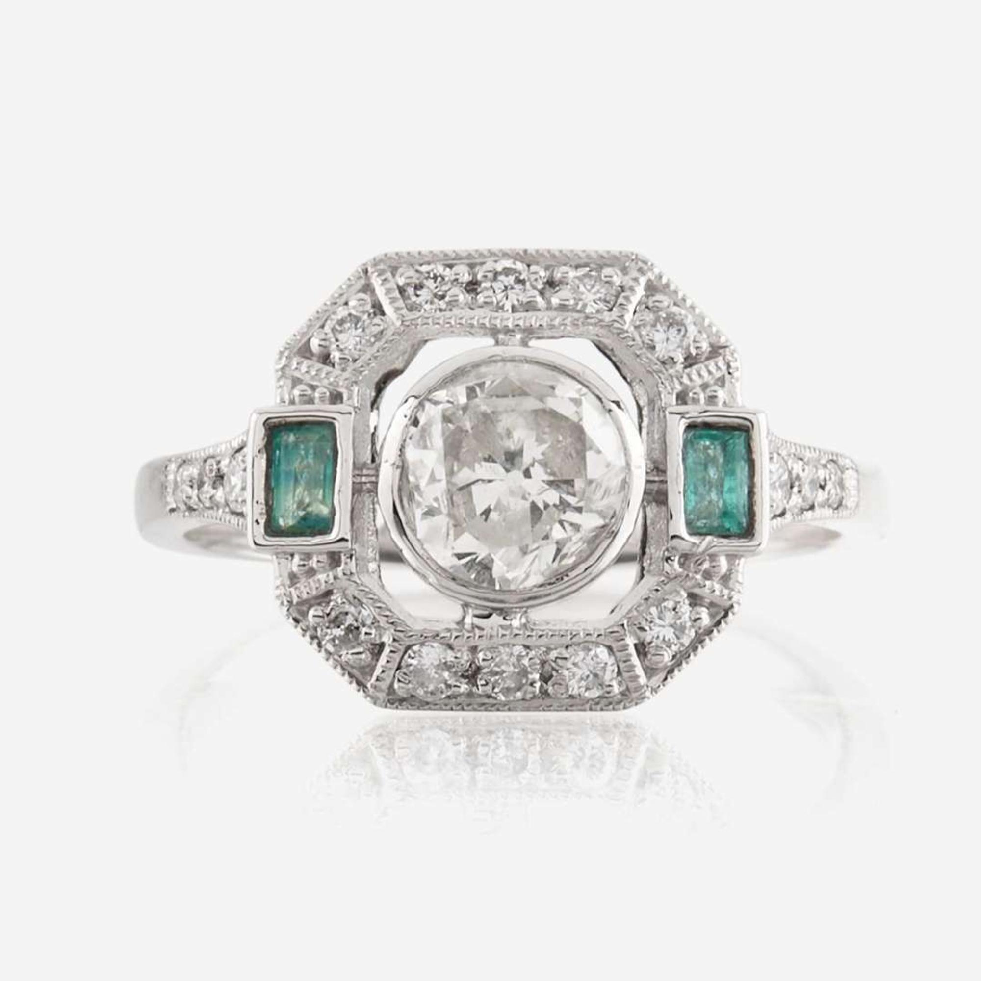 A diamond, emerald, and platinum ring