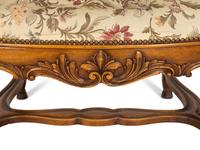 A Set of Eight Régence Style Carved Walnut Fauteuils