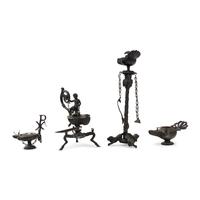 A Collection of Four Patinated Bronze Oil Lamps