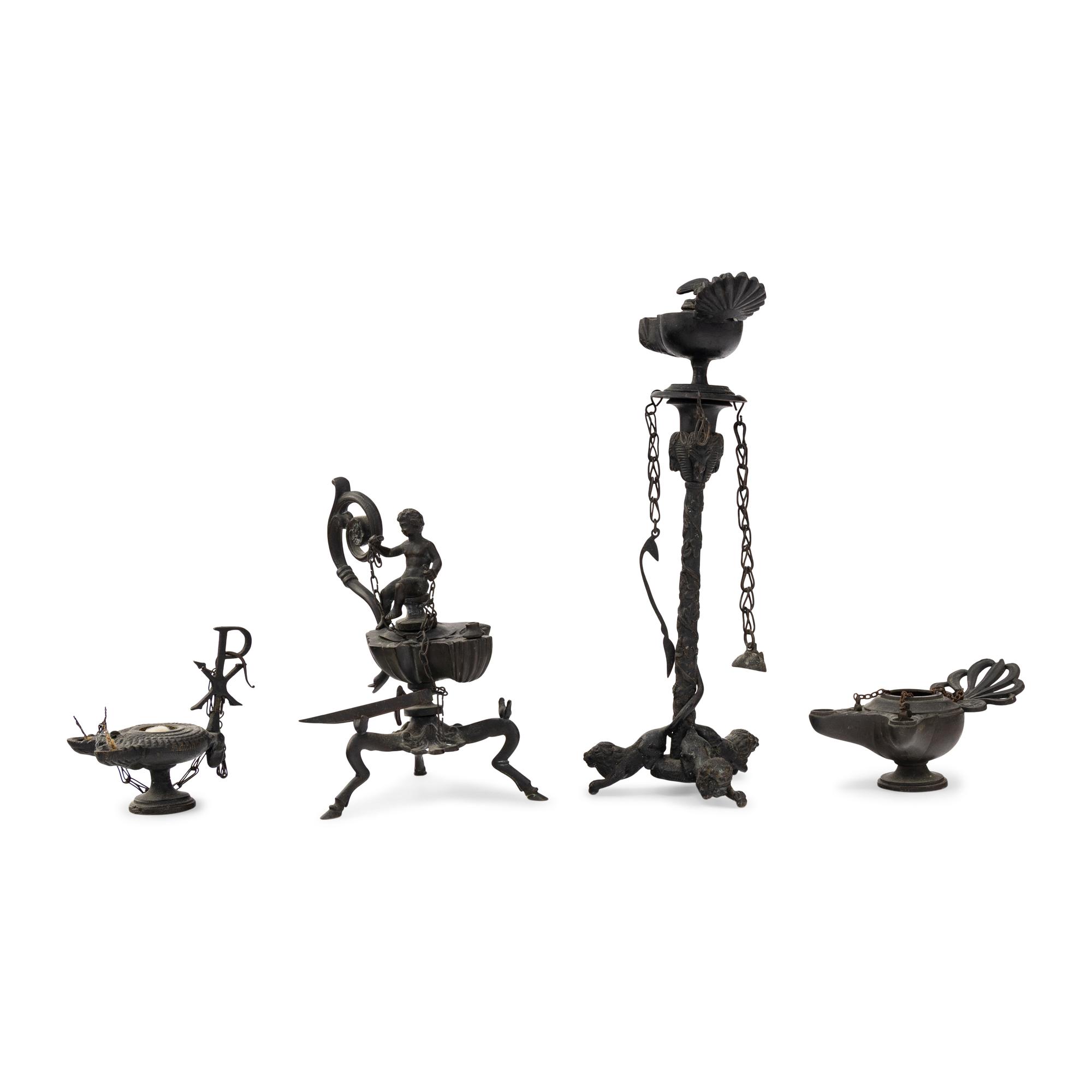 A Collection of Four Patinated Bronze Oil Lamps