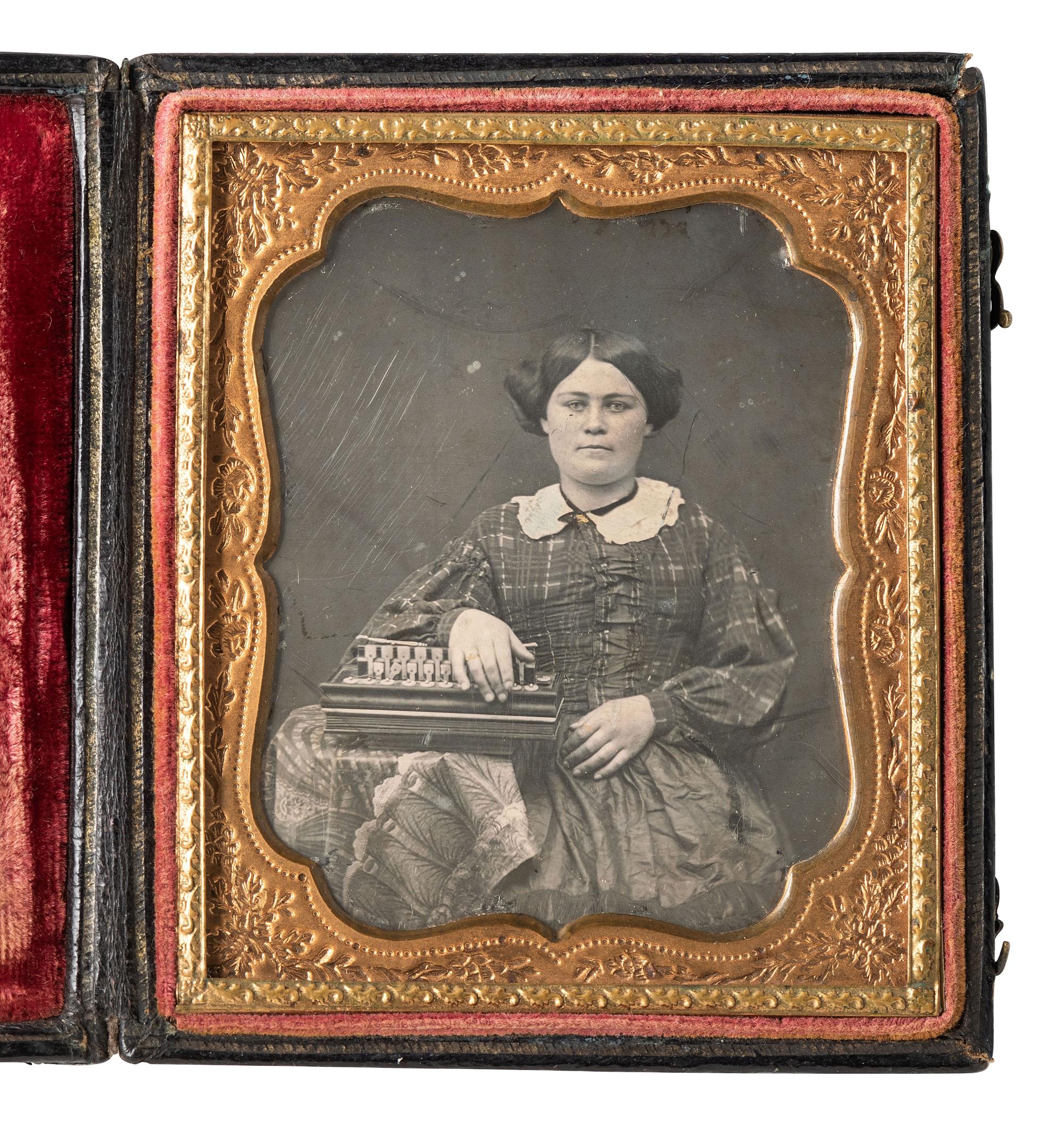 [EARLY PHOTOGRAPHY]. Sixth plate daguerreotype featuring a full-figured woman with a flutina.