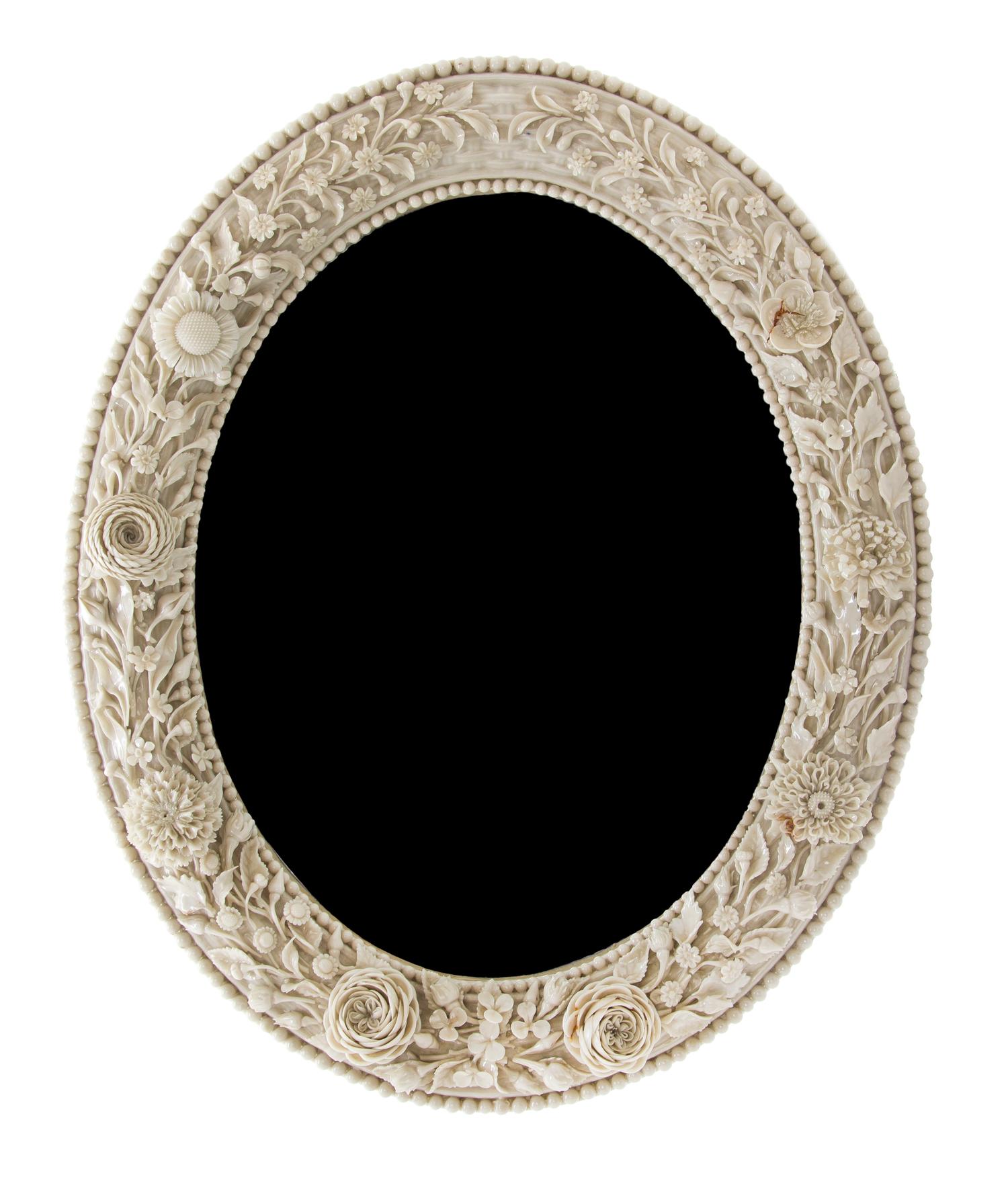 A Belleek Flowered Mirror, Height 15 3/4 x width 13 inches.