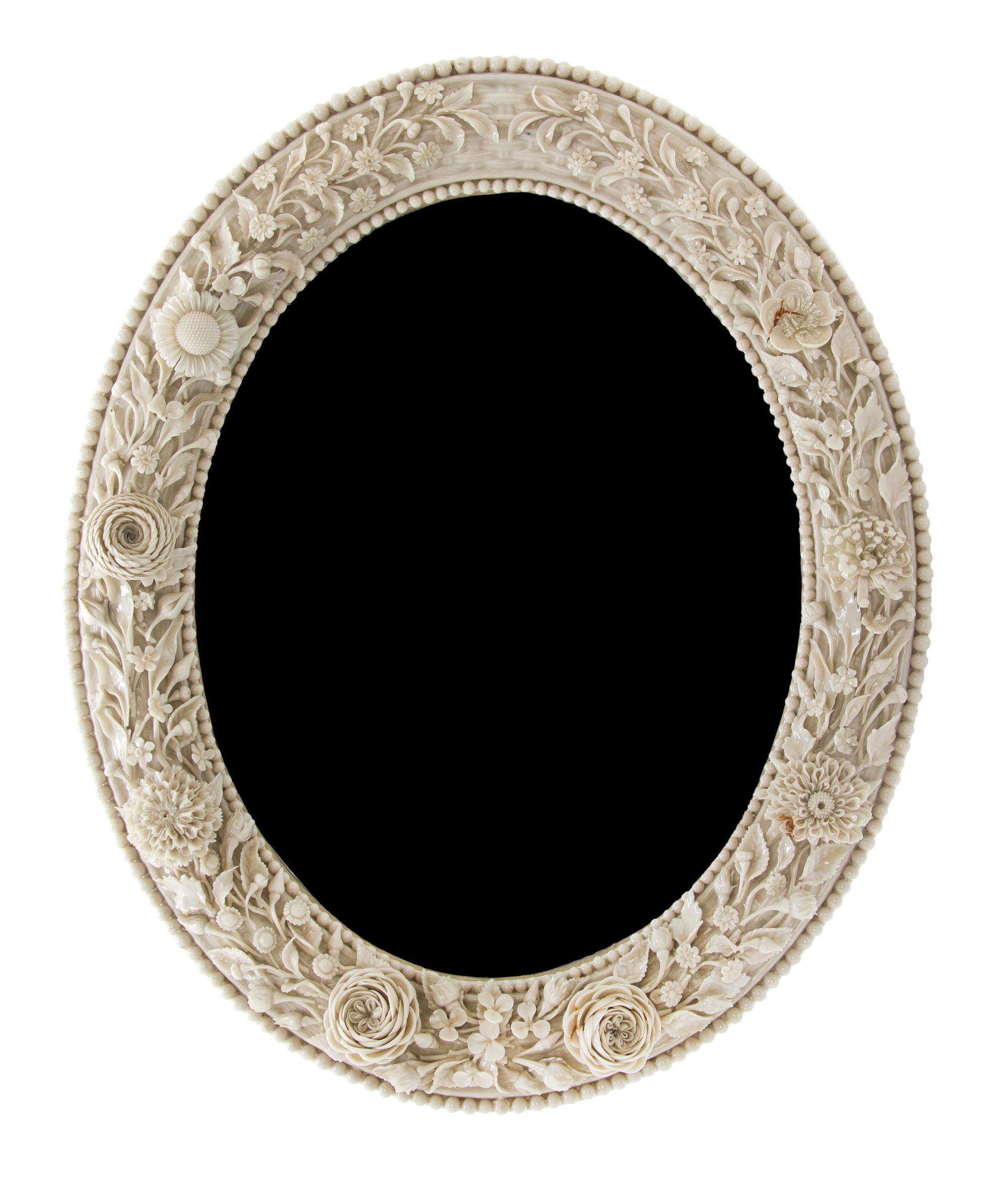 A Belleek Flowered Mirror, Height 15 3/4 x width 13 inches.