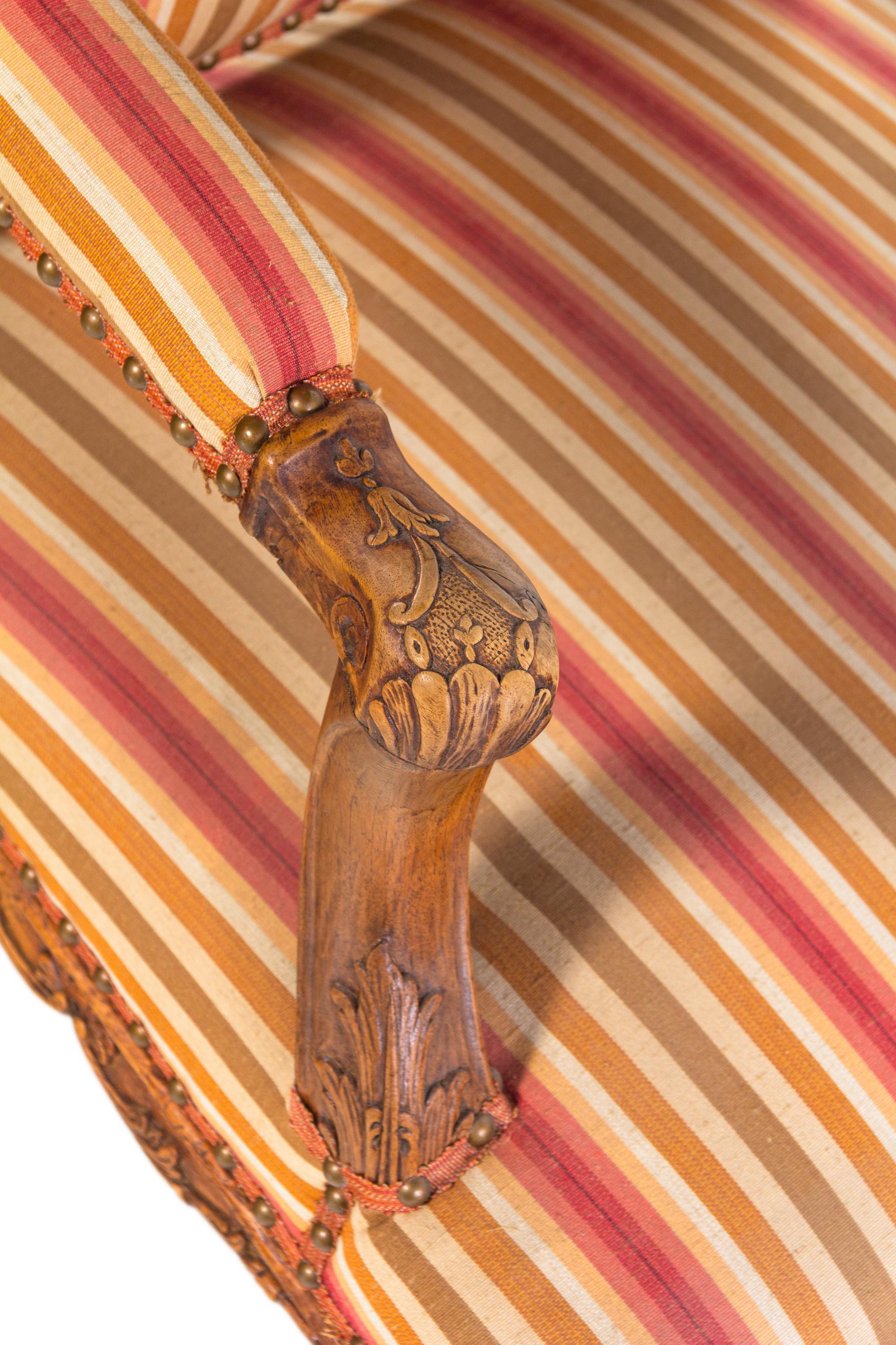 A Pair of Régence Carved Walnut Armchairs