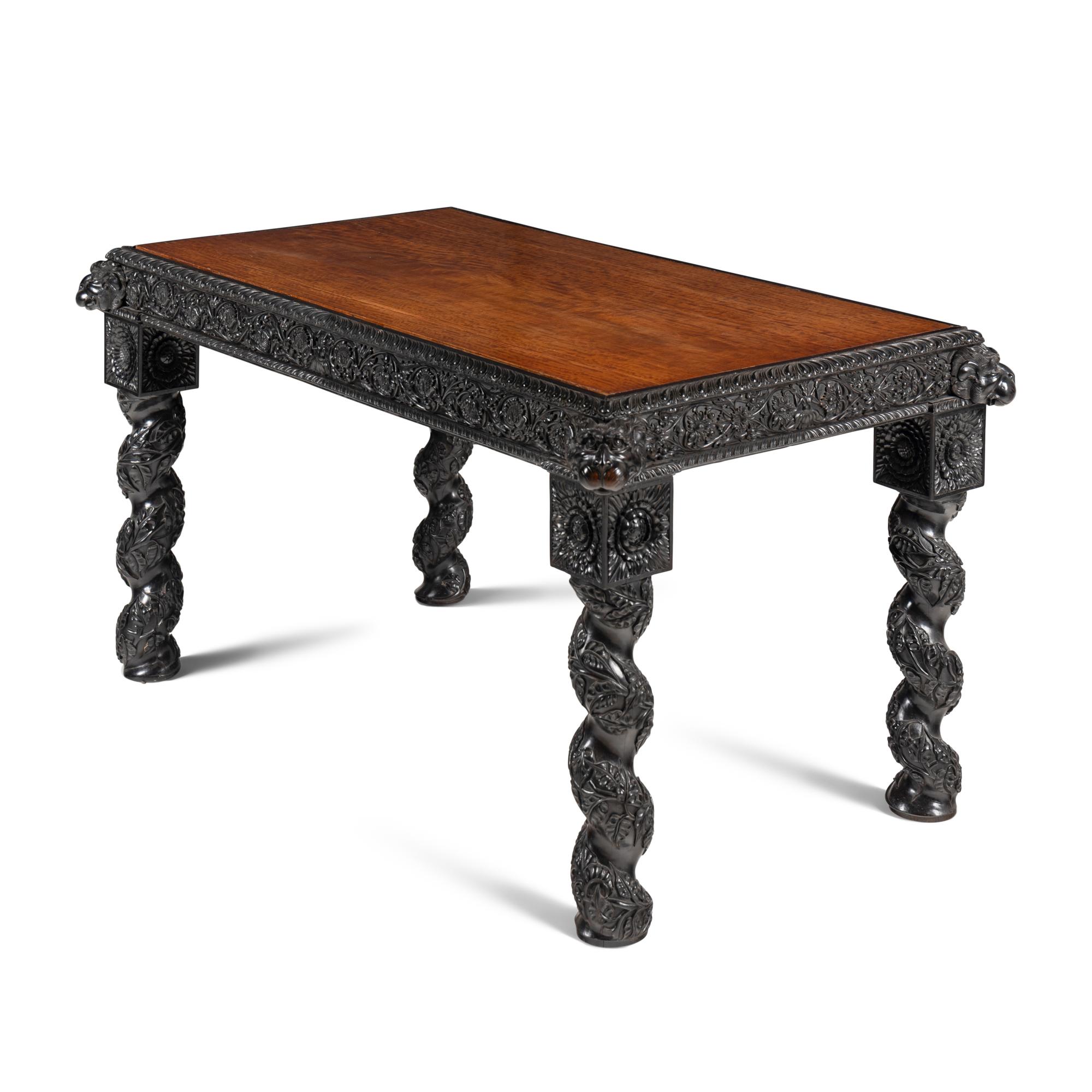 An Anglo-Colonial Carved Ebony and Satinwood Center Table