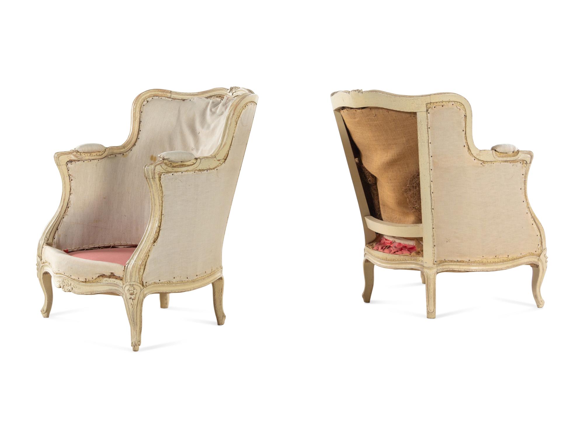 A Pair of Louis XV Carved and White-Painted Low Bergères