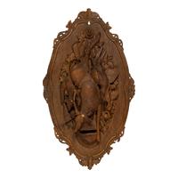A Pair of Swiss "Black Forest" Carved Lindenwood Game Plaques