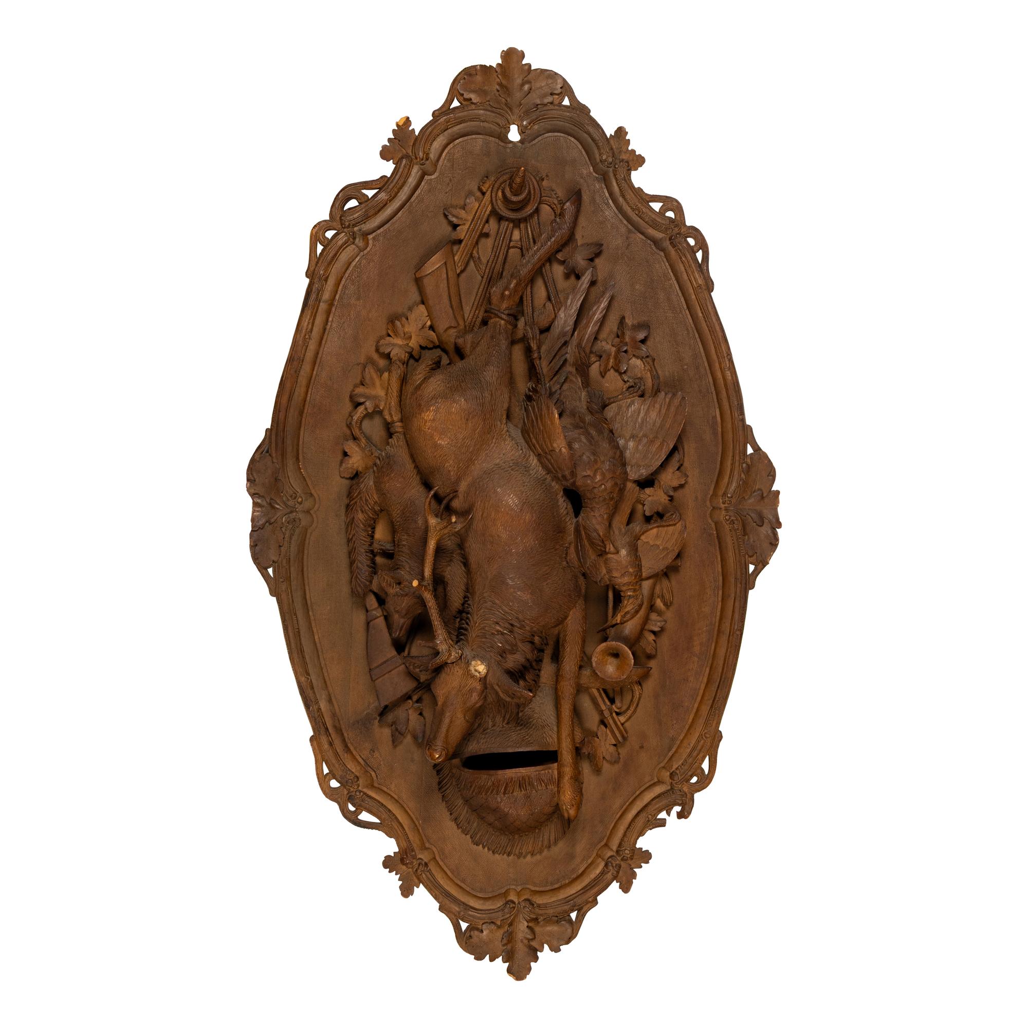 A Pair of Swiss "Black Forest" Carved Lindenwood Game Plaques