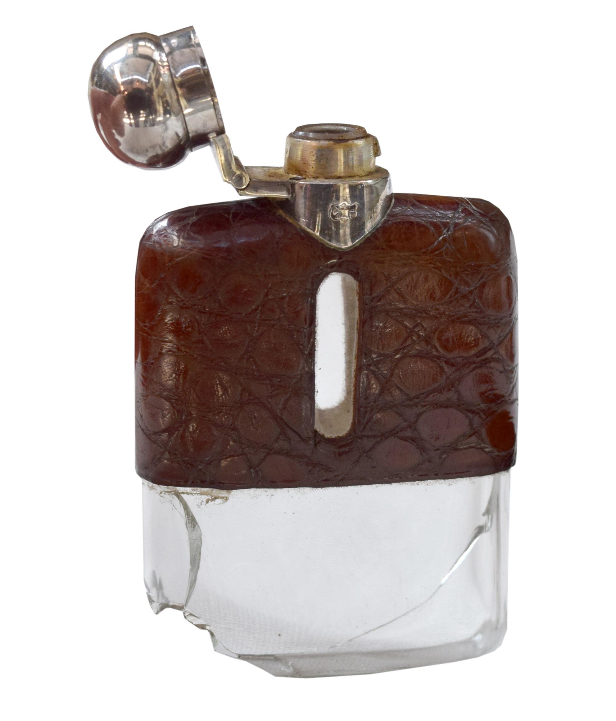 A Set of Three Silver and Stamped Leather Hip Flasks Left: 2.25" x .5" x 3.75" tall: Middle: 3" x 1" x 5" tall: Right: 3.25" x 1" x 5.5 — England, Circa 1925-1940