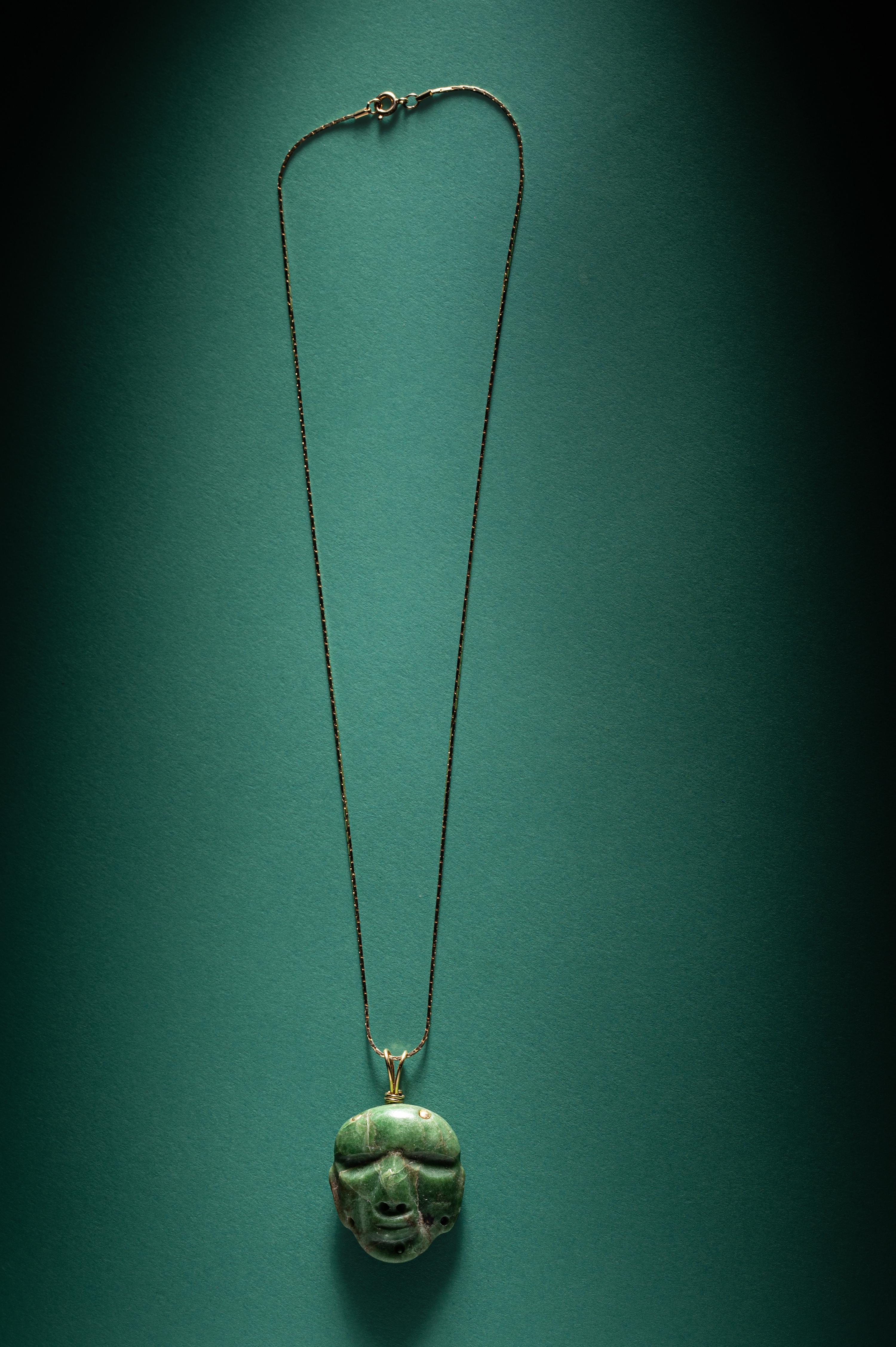 A Chontal Jade Maskette Pendant Necklace with Gold Chain