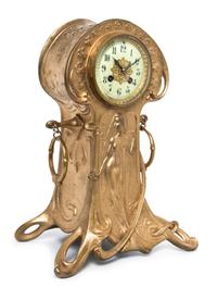 A French Art Nouveau Gilt Metal Mantel Clock, retailed by Caldwell, Height 15 inches.