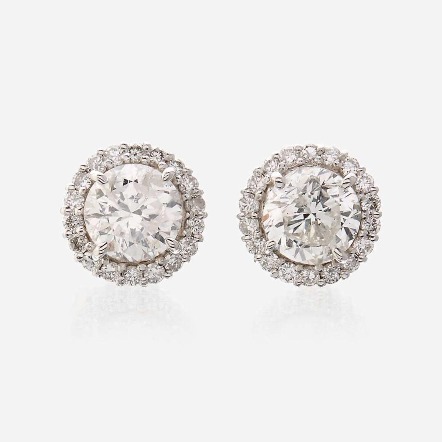 A pair of diamond and eighteen karat white gold earrings