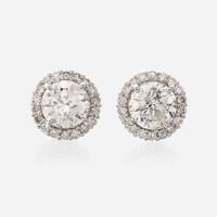 A pair of diamond and eighteen karat white gold earrings