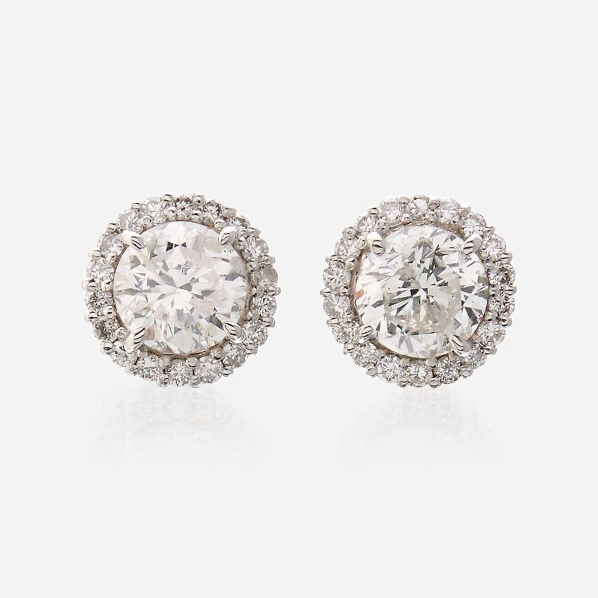 A pair of diamond and eighteen karat white gold earrings