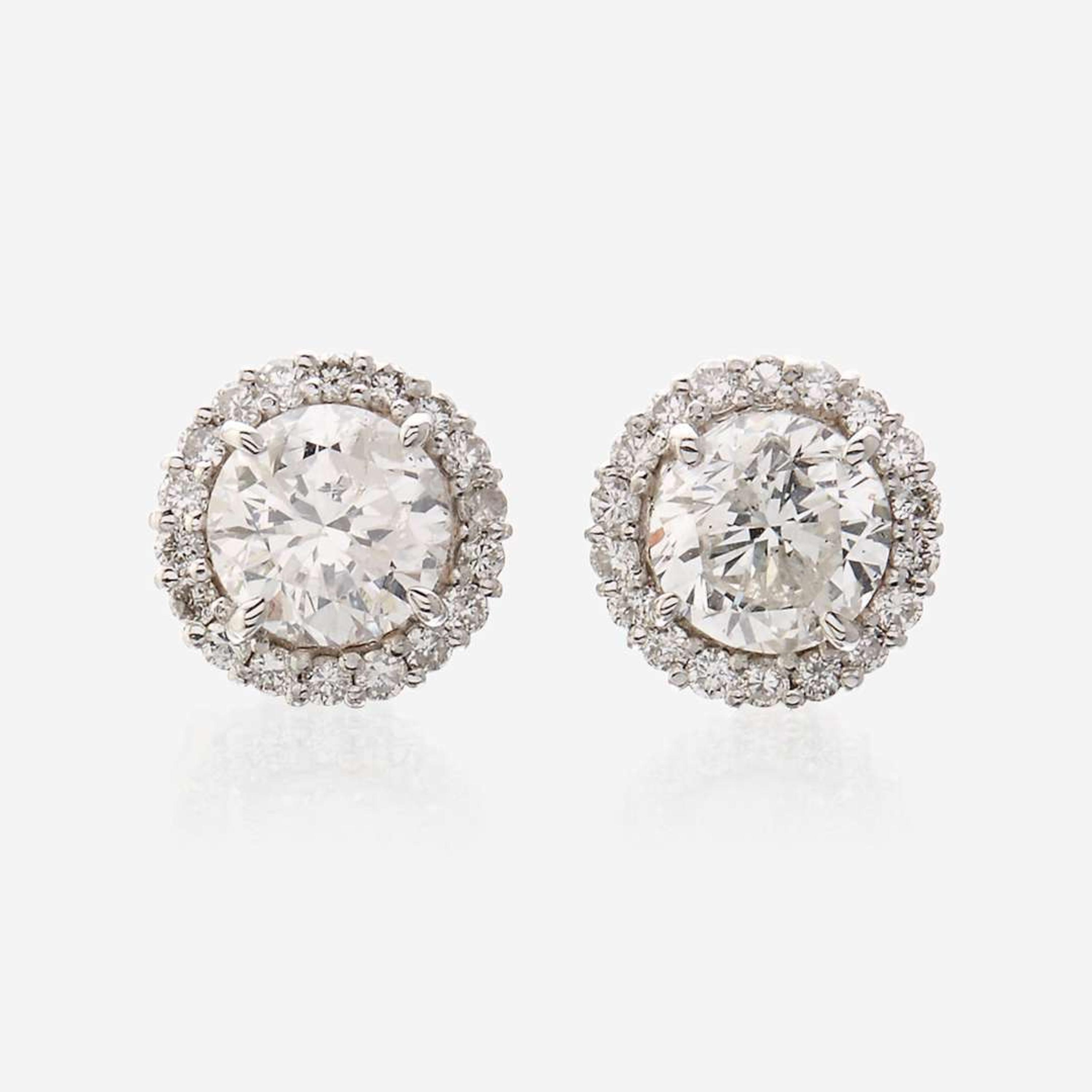 A pair of diamond and eighteen karat white gold earrings