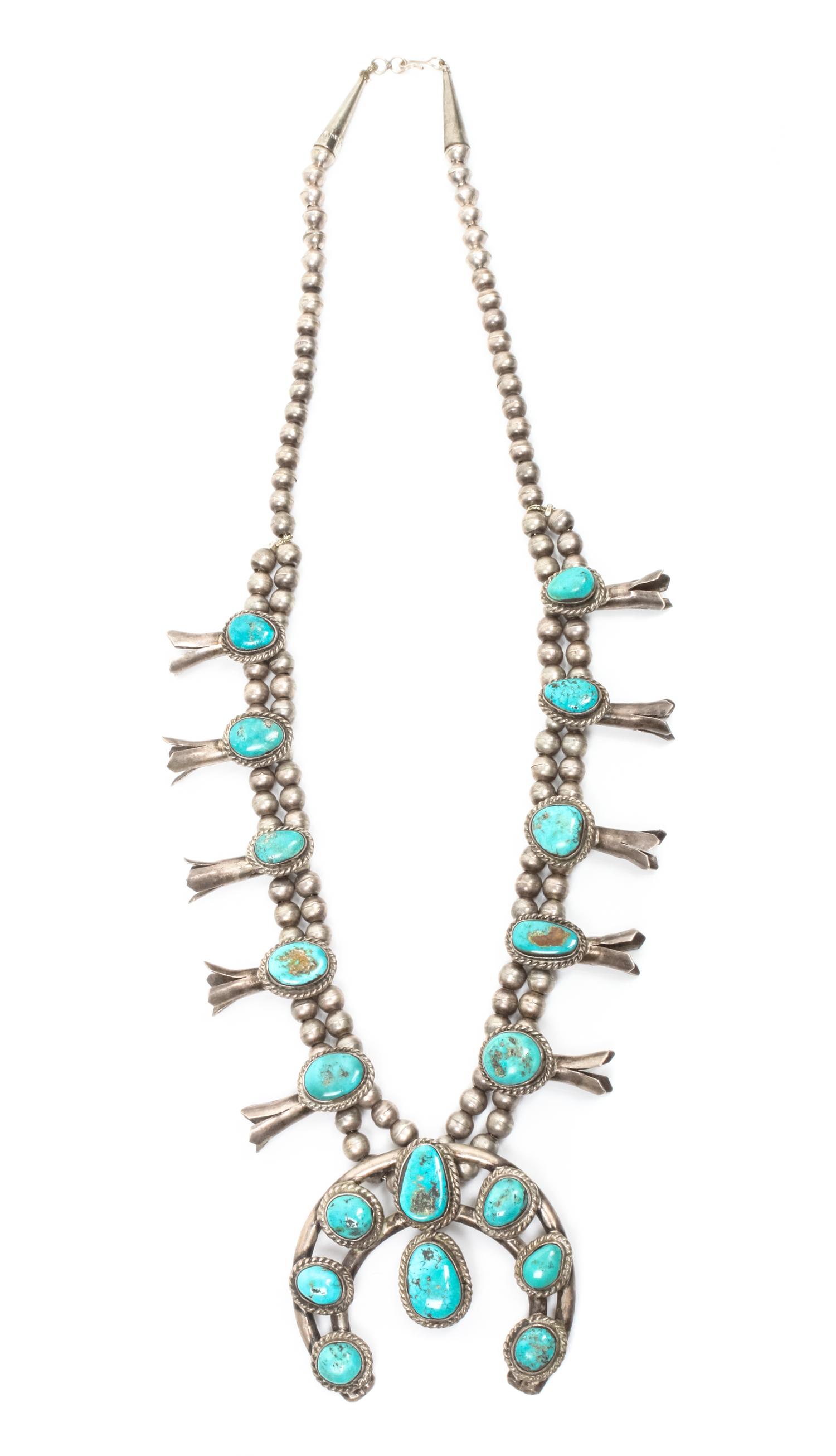 A Navajo Silver and Turquoise Squash Blossom Necklace Length 25 plus naja height 2 /14 x width 2 1/2 inches.