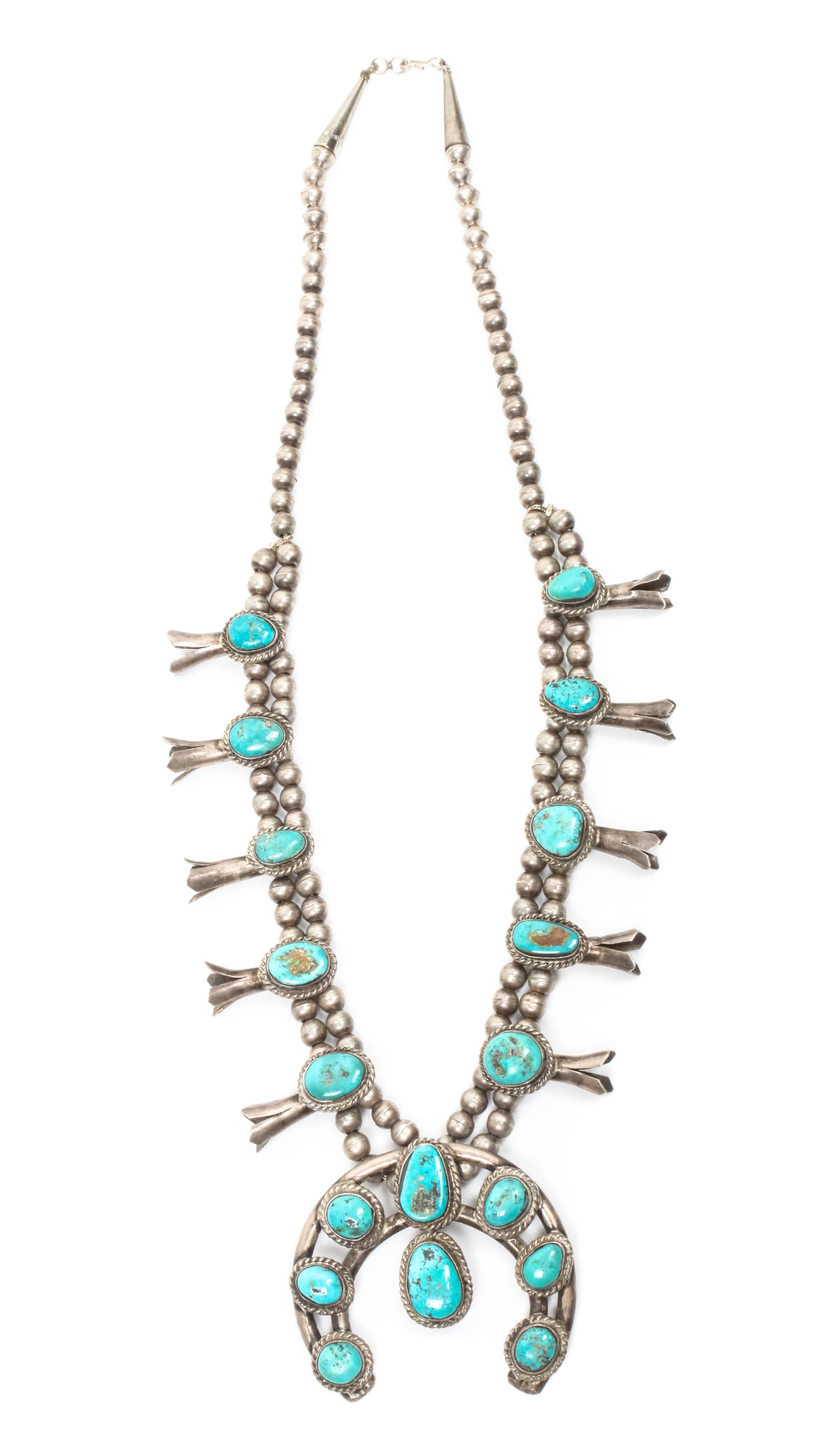 A Navajo Silver and Turquoise Squash Blossom Necklace Length 25 plus naja height 2 /14 x width 2 1/2 inches.
