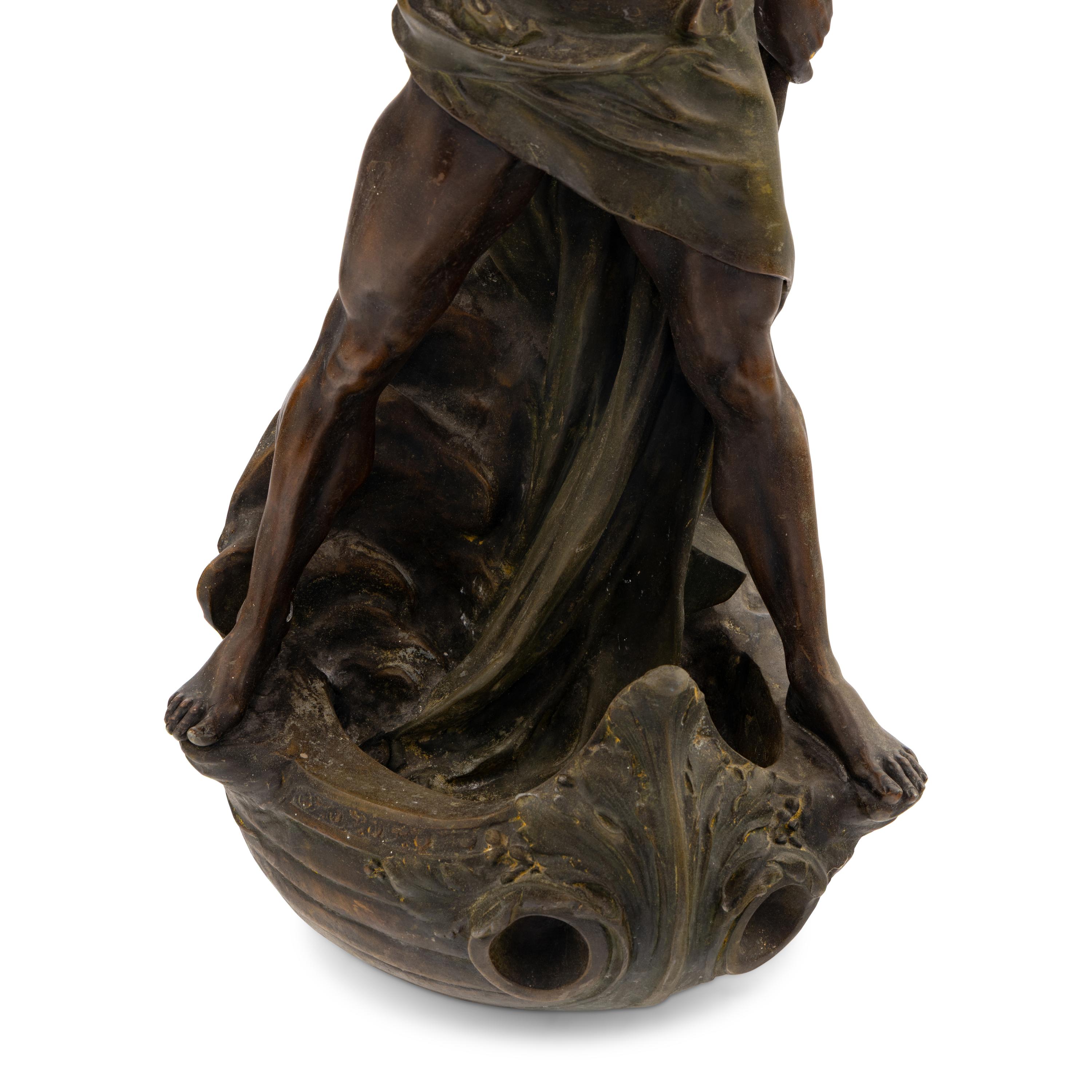 A Cast Metal Figural Newel Post Lamp