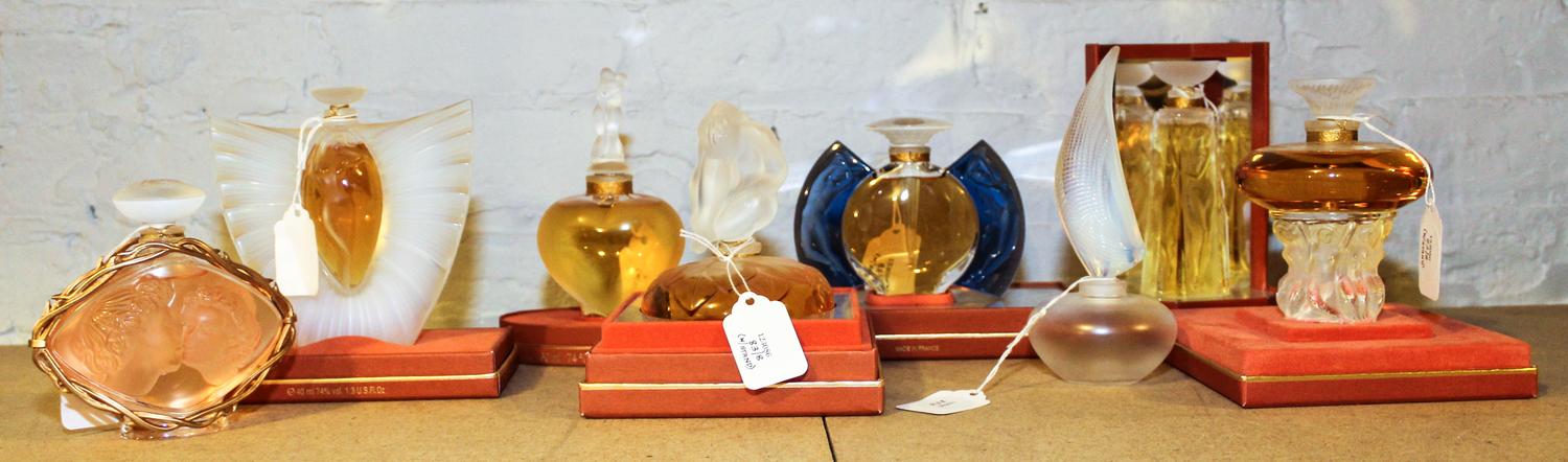 A Group of Eight Lalique Glass Perfume Bottles. Height of tallest 5 inches.
