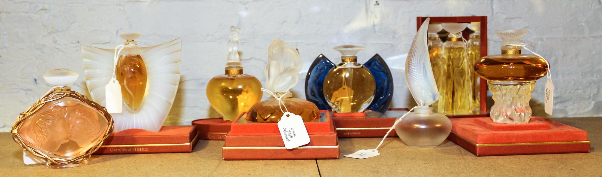 A Group of Eight Lalique Glass Perfume Bottles. Height of tallest 5 inches.