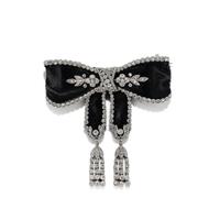 ART DECO, BLACK RIBBON, DIAMOND, AND PLATINUM BOW BROOCH