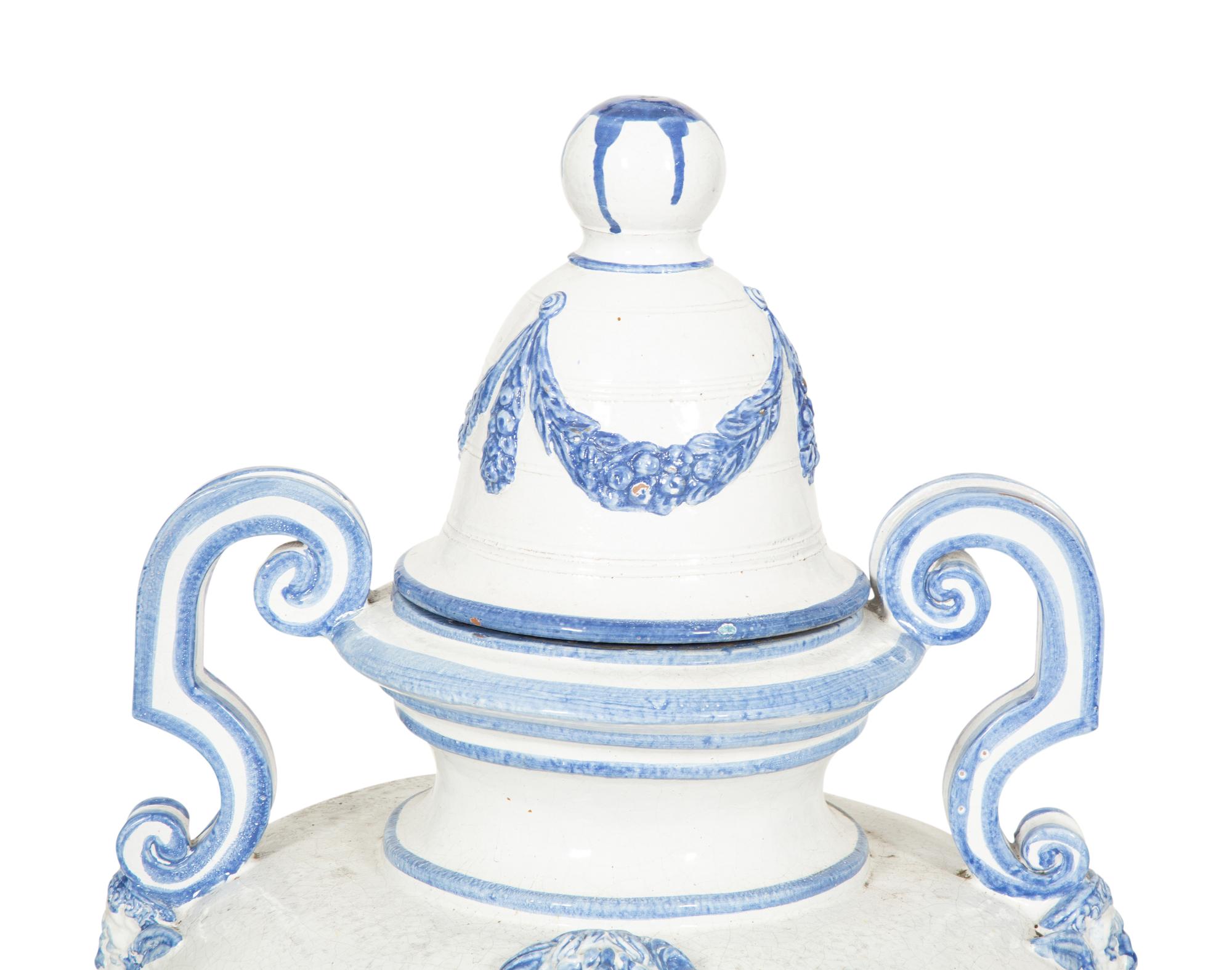 A Pair of Italian Blue and White Glazed Ceramic Covered Urns