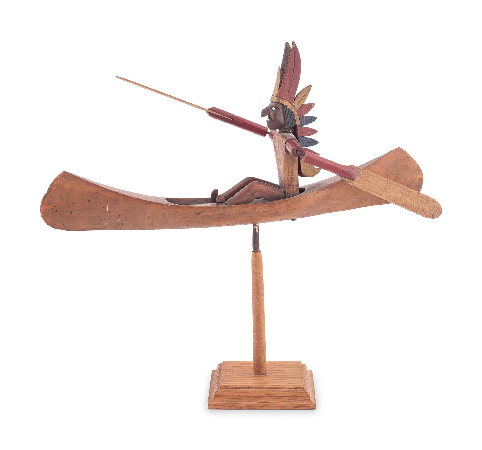 A Folk Art Whirligig of an American Indian in a Canoe