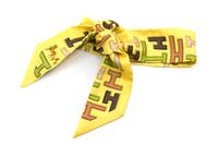 An Hermes Silk Twilly Scarf.